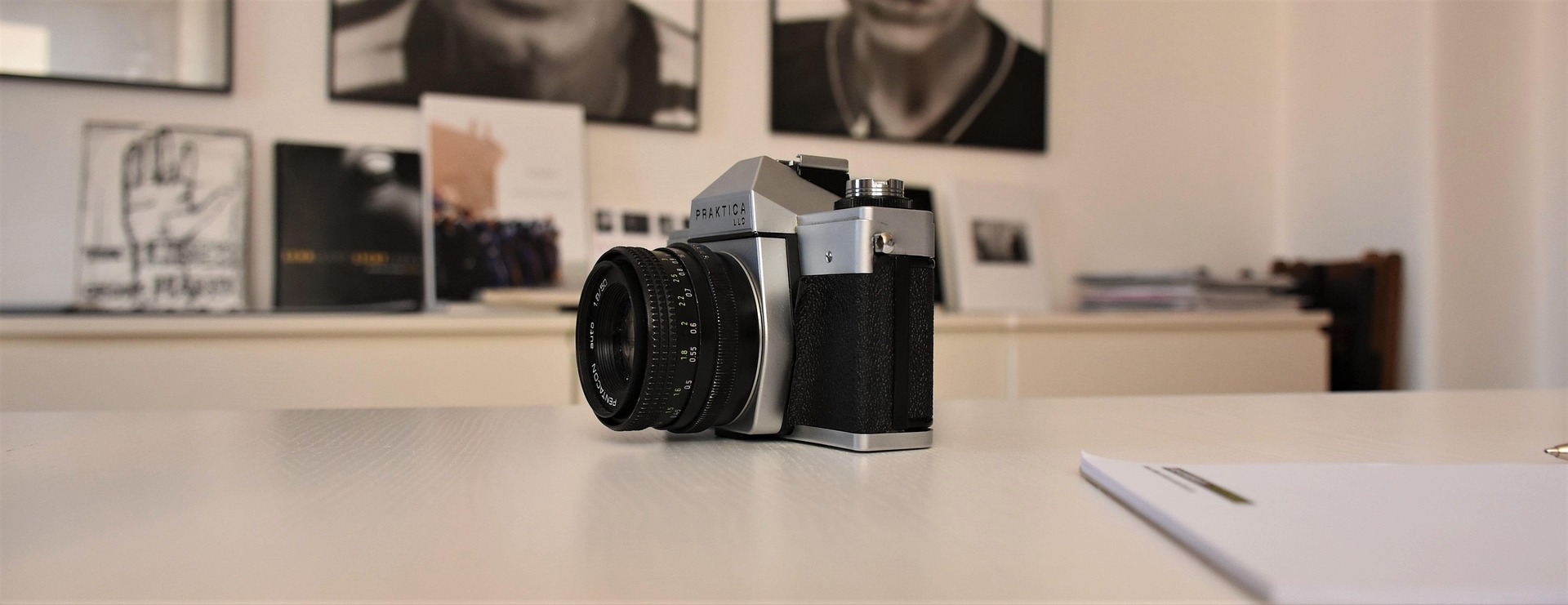 Vintage 35mm camera on a desk — illustrating the traditional reseller home photo studio approach this guide compares against AI alternatives