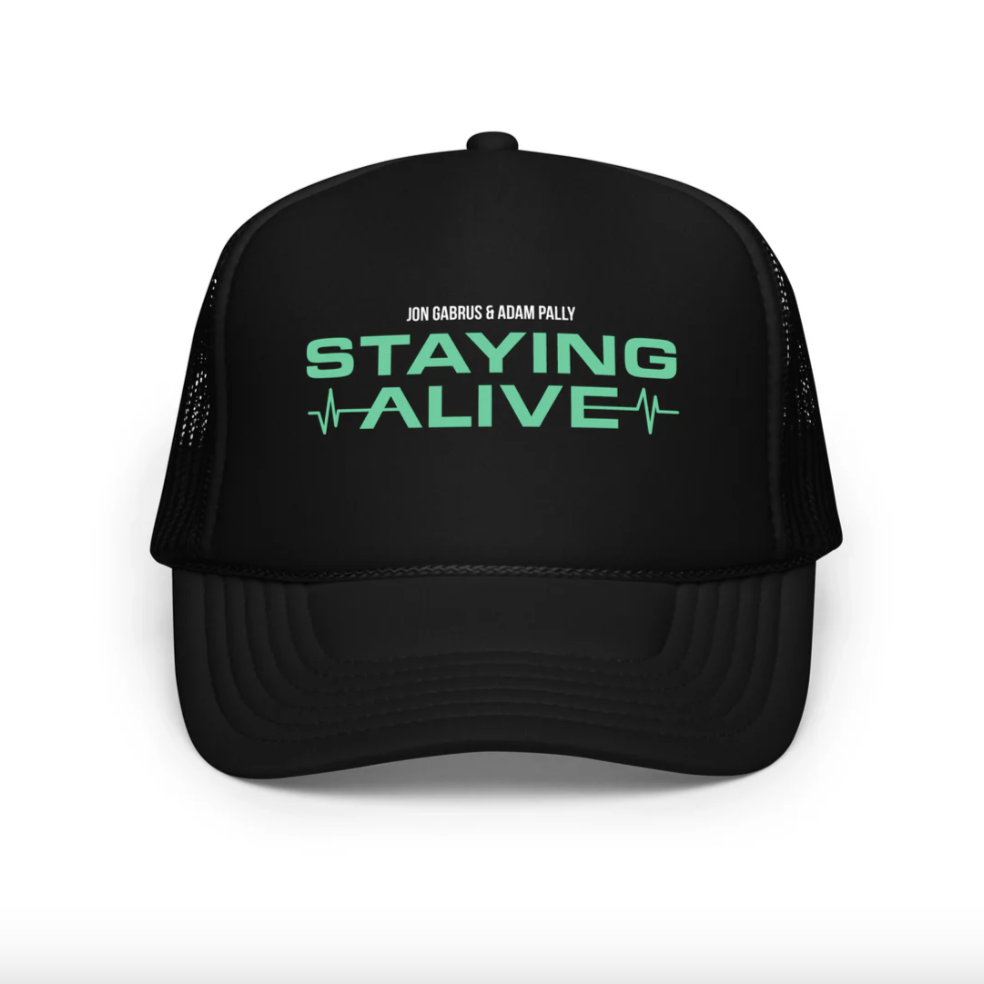Print-on-demand baseball cap source photo — embroidered or printed design on a plain dad-cap or snapback against neutral studio backdrop, before AI lifestyle scene generation
