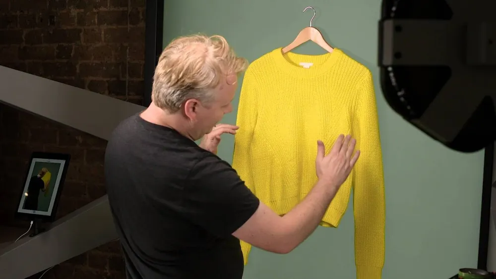 Studio demonstration of photographing a sweater on a hanger