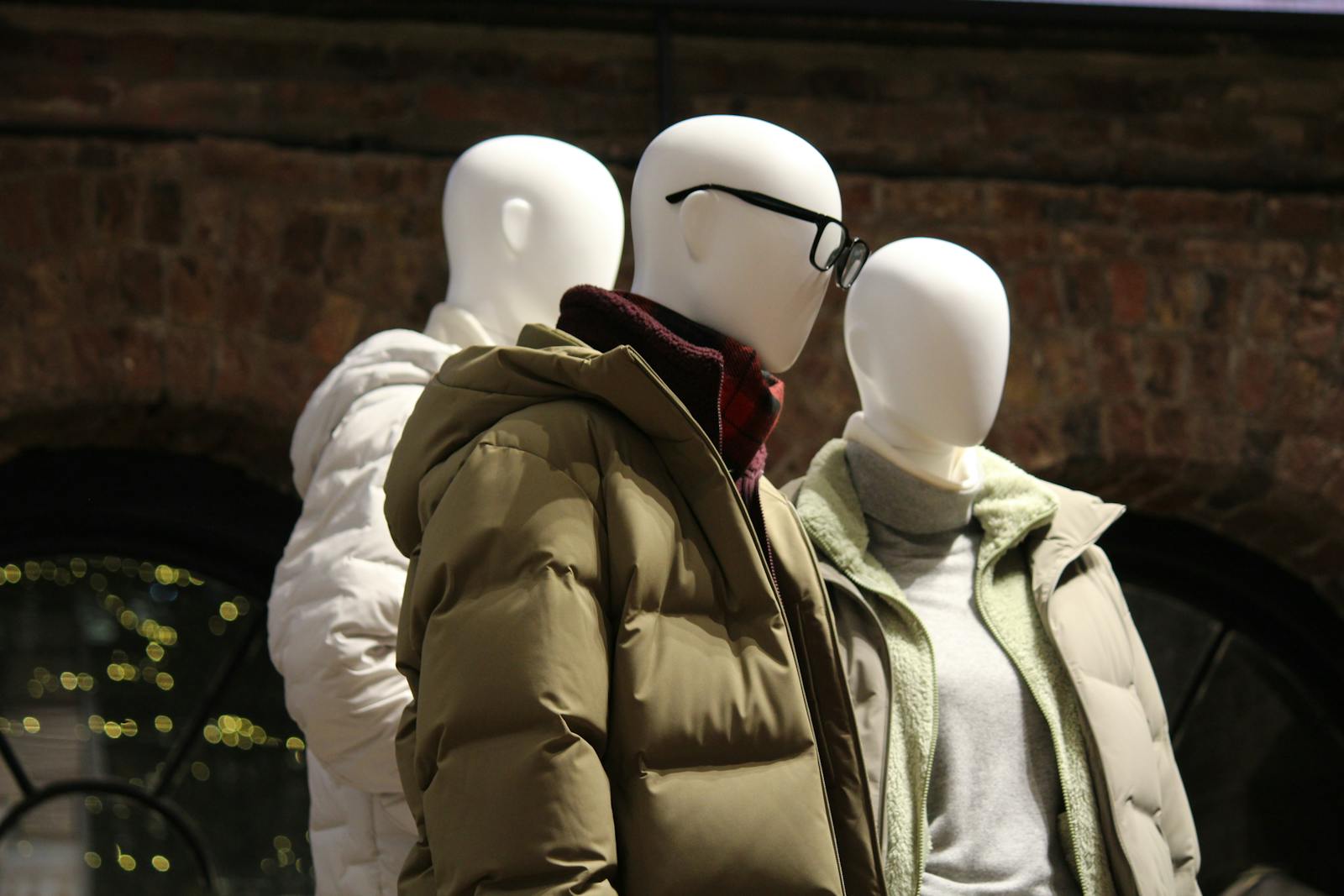 Winter puffer and fleece jackets displayed on mannequins, the garments shown with full three-dimensional shape on the mannequin