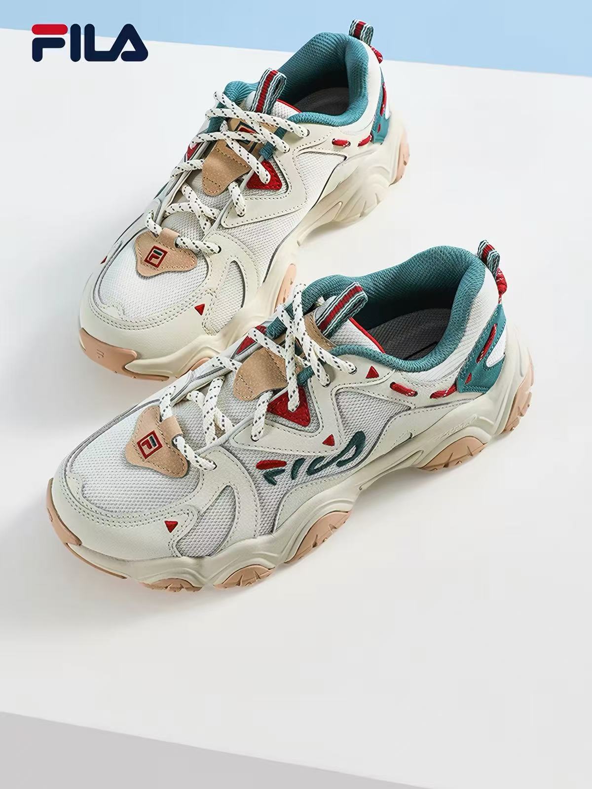 FILA chunky trainer in cream with teal and red trim and a tan gum sole, shot as a product packshot
