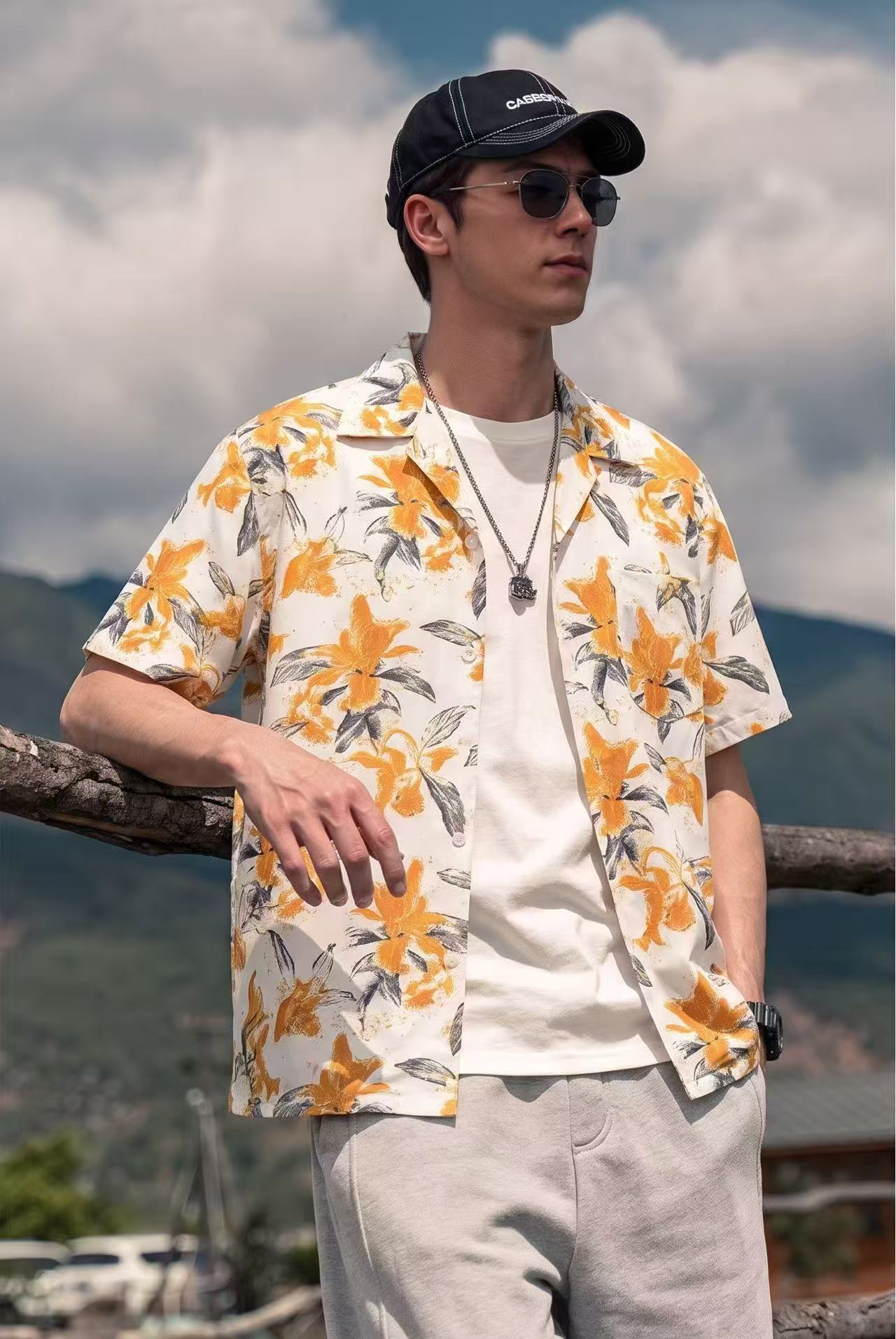 Snappyit AI model output — the orange lily print camp-collar shirt rendered on a generated model