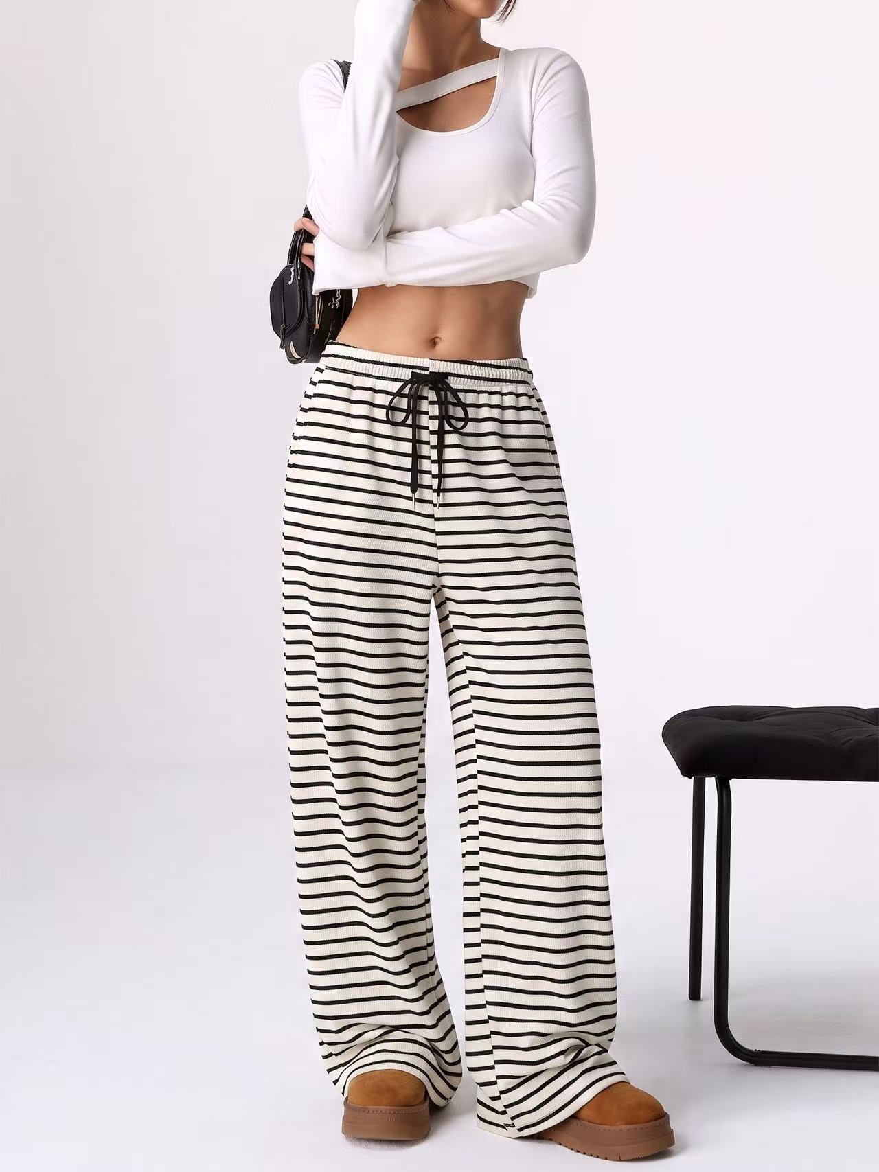 Snappyit AI model output — the black and white striped wide-leg pants rendered on a generated model