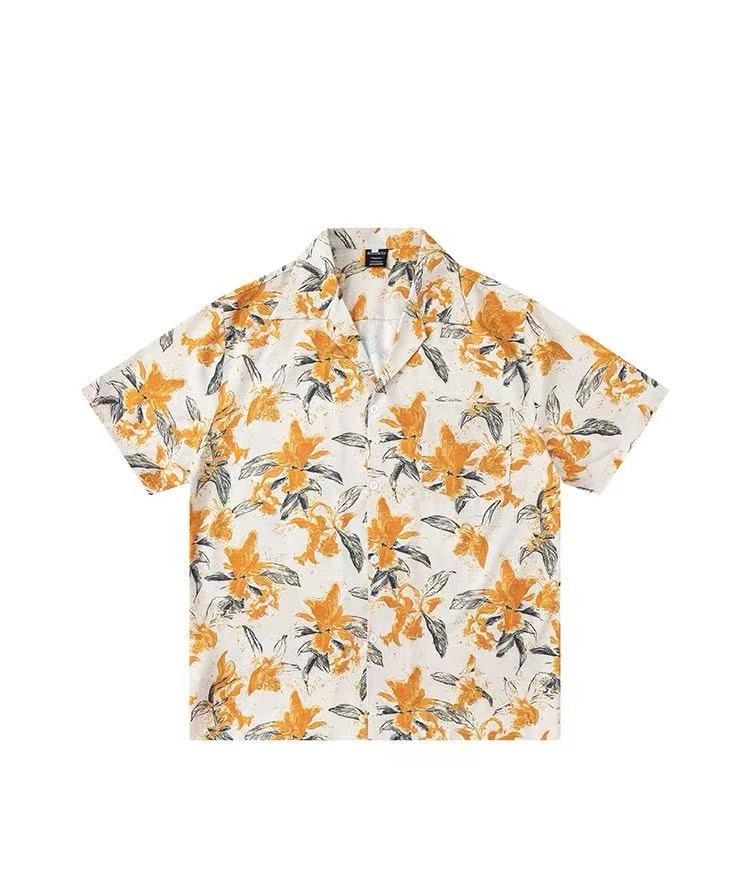 Source photo — orange lily print camp-collar shirt photographed as a clean flat-lay on white
