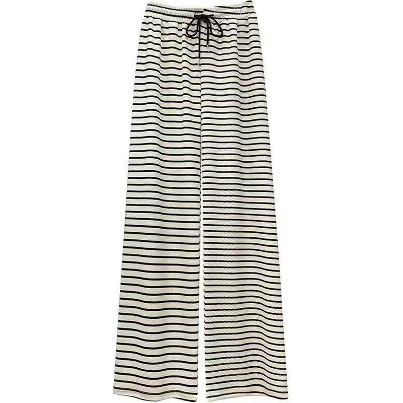 Source photo — black and white horizontal striped wide-leg drawstring pants photographed as a clean flat-lay on white