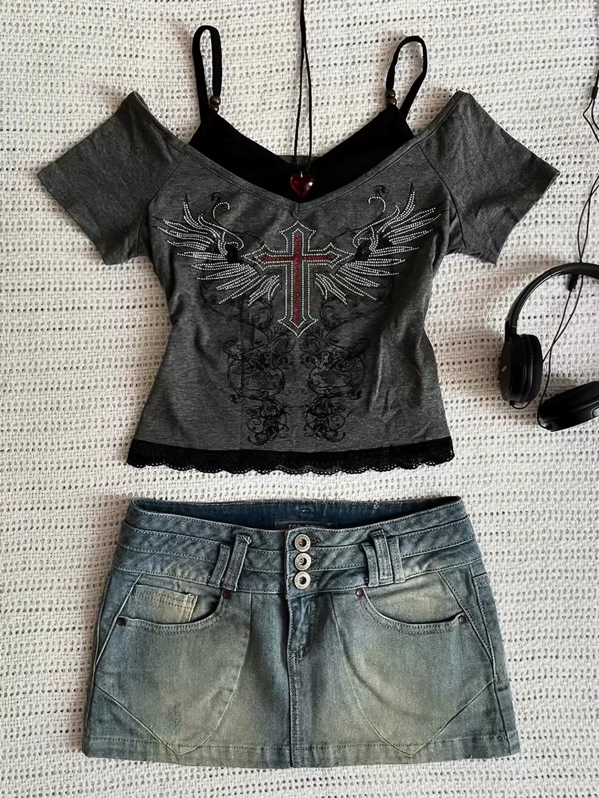 Y2K gray graphic top and denim mini skirt arranged as a styled flat lay