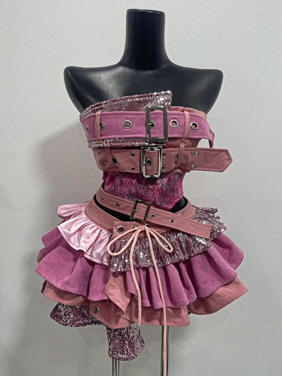 Original pink Y2K belt-and-ruffle garment displayed on a black mannequin