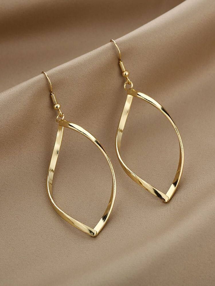 Raw photo of gold drop earrings on satin supplier backdrop
