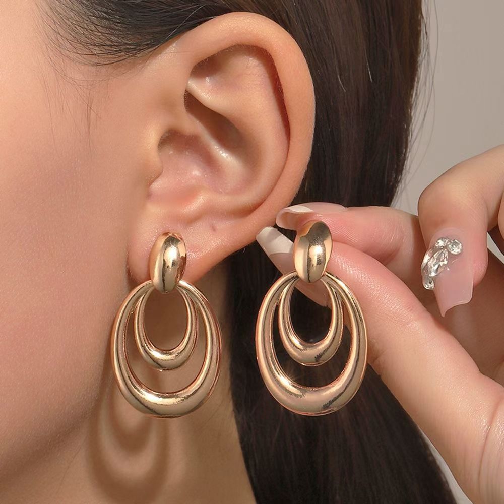 After AI Jewelry Model: the same gold double-hoop earrings placed on a model ear template at natural scale