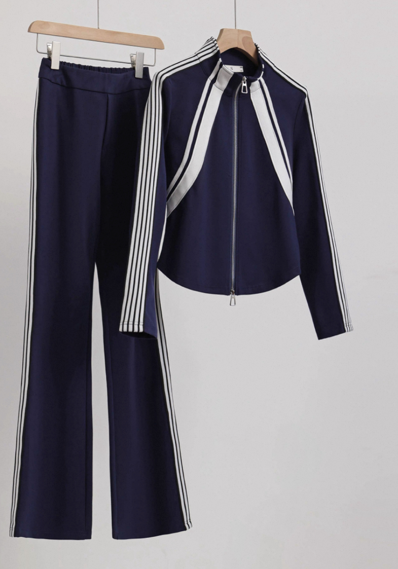 A navy striped tracksuit jacket and pants on a wooden hanger (raw hanger shot)