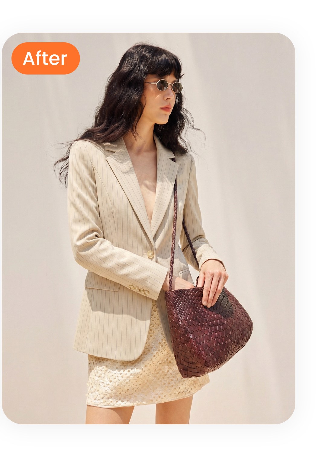 Same pinstripe blazer styled on an AI female model with vintage tote in office-ready setting