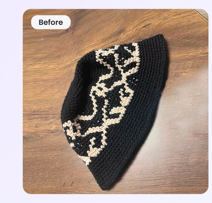 Handcrafted black-and-cream crochet bucket hat photographed flat on hardwood &mdash; phone input photo
